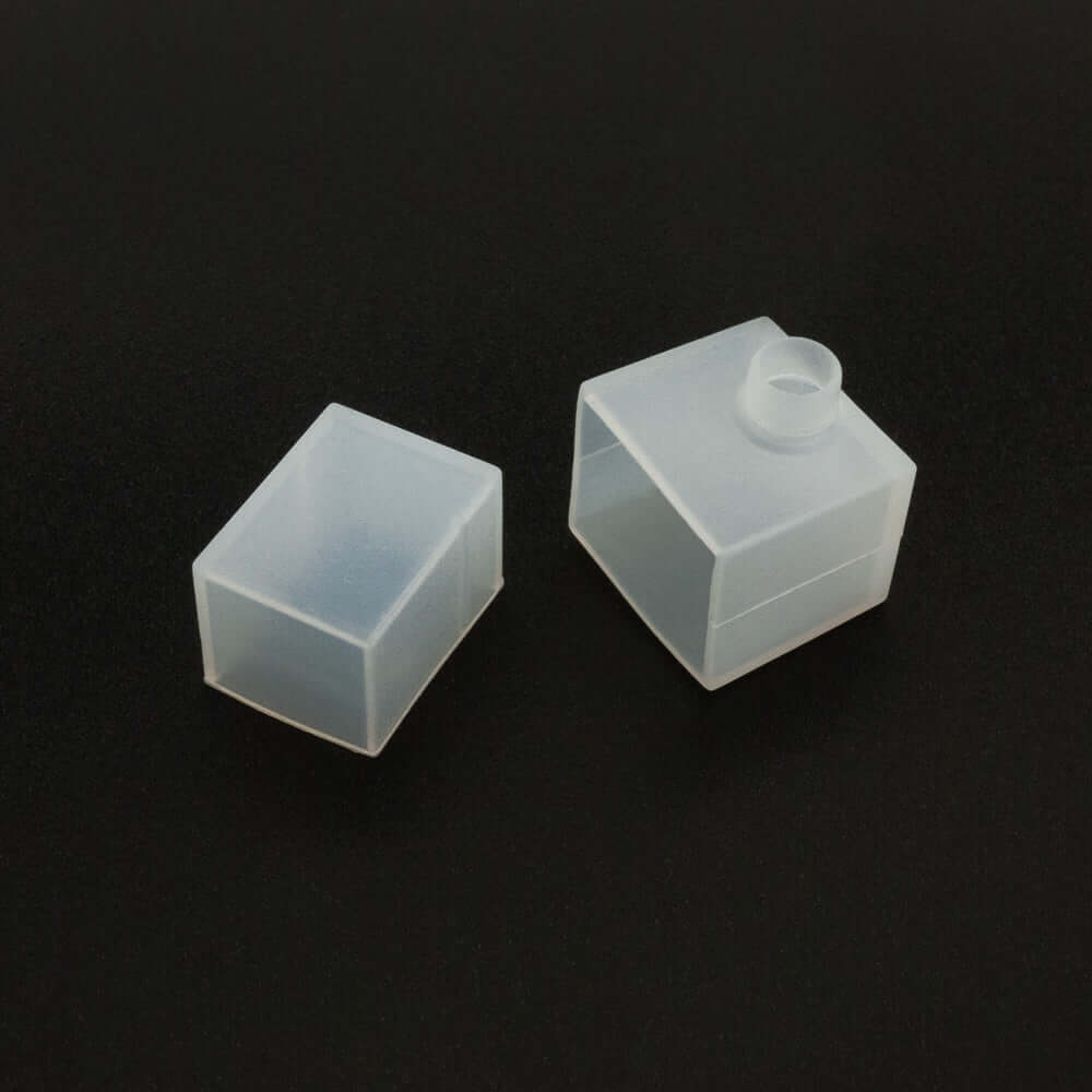 Transparent silicone caps, one closed, one open, suitable for various applications and protective uses.