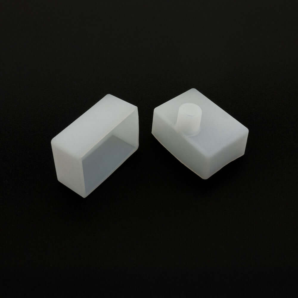 Two white silicone flexible LED neon channel end caps on a black background.