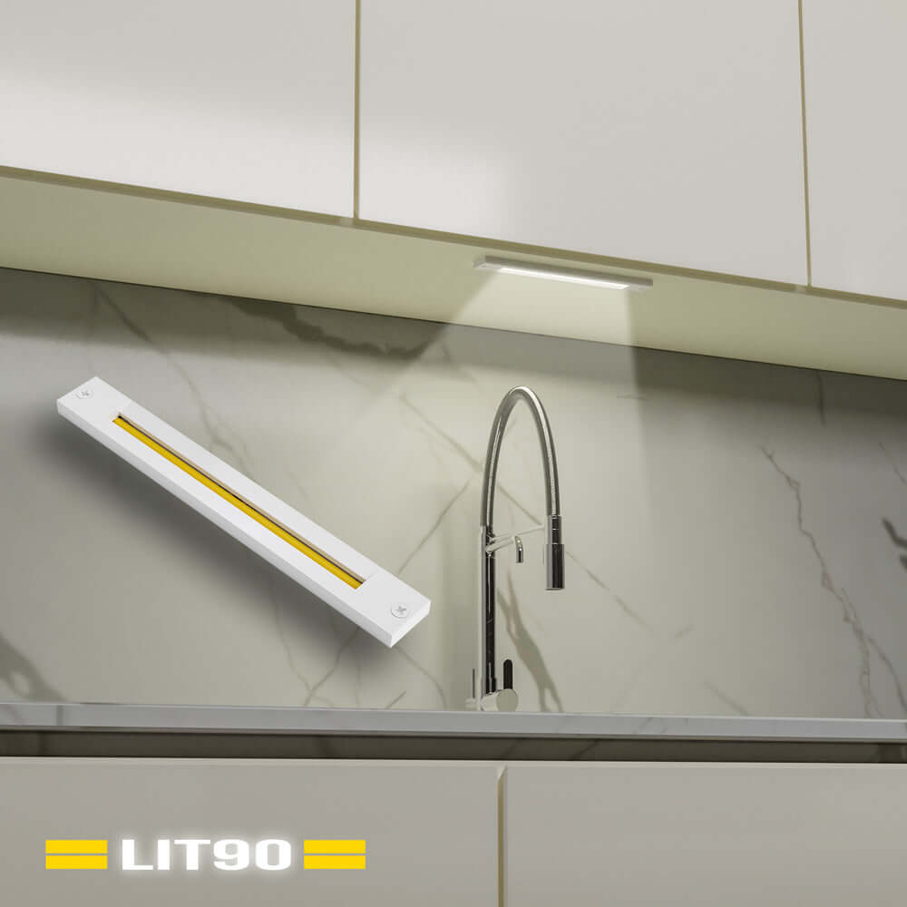 Linear cabinet light with white body illuminating modern kitchen countertop.